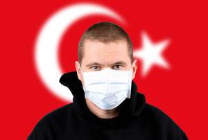 Man wearing protection face mask with flag of Turkey