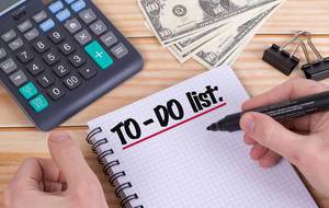 Man writing To do list in notebook