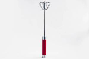 Manual whisk rotary egg beater on white background. Cooking tool.