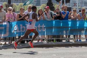 Marathon runner with both feet in the air