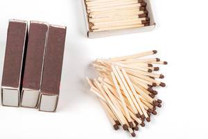 Matchbooks and scattered matches on a white background