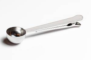 Measured coffee spoon on a white background