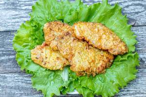 Meat chops fried in batter with lettuce leaves
