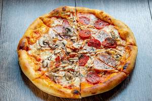 Meat-pizza-with-mushrooms-bacon-chicken-cheese-and-smoked-sausage.jpg