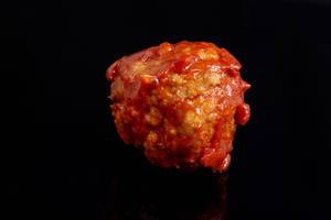 Meatballs with Tomato Sauce on the black background