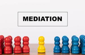 Mediation concept with pawn figurines on table