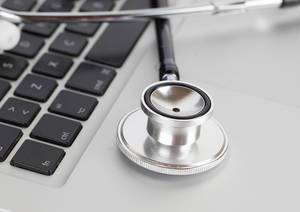 Medical stethoscope on a modern laptop