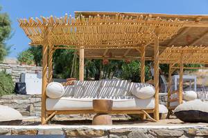 Mediterranean outdoor furniture on a sun terrace of a bar at Monastiri Beach on Paros Island, Greece