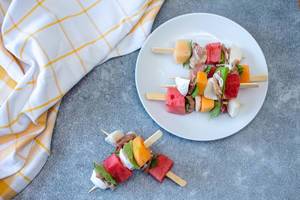 Melon, prosciutto and cheese  skewers top view