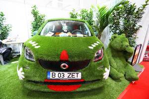 Mercedes Smart car covered in green grass at Bucharest Auto Show, 2019 SAB