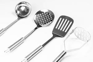 Metal kitchen utensils on white background (Flip 2020)