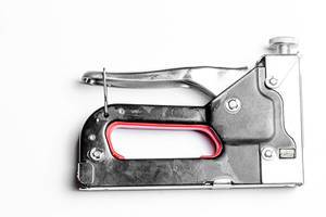 Metal manual stapler on a white background