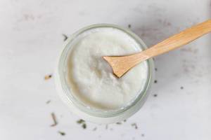 Milk product yogurt in a glass with wooden spoon