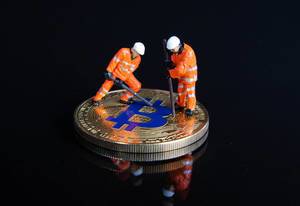 Miner figures working on a Bitcoin