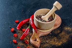 Mix peppers in wooden mortar and chili pepper