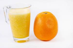 Mixed Orange juice with whole Orange on the white table (Flip 2019)