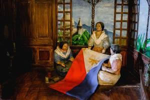 Model of women sewing the Philippine flag