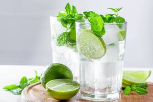 Mojito cocktail with ice cubes and fresh lime