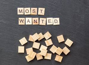 Most wanted set with wooden tiles on a stone surface