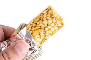 Muesli Bar in the hand above white background