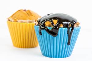Muffins mit Vanillegeschmack und Schokoladensoße als Topping