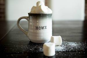 Mug with marshmallows on wooden table