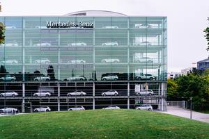 Multi-stories Mercedes-Benz glass showroom with silver cars in Munich, Germany