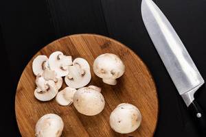 Mushrooms on the wooden board with knife