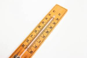 Nahaufnahme von Wand-Thermometer aus Holz vor weißem Hintergrund