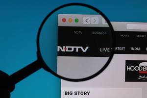 NDTV logo under magnifying glass