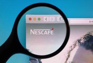 Nescafe logo under magnifying glass