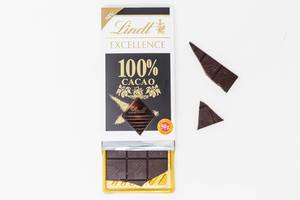 New product by Lindt: Lindt Excellence 100% cacao chocolate bar, package open with some loose pieces on white background