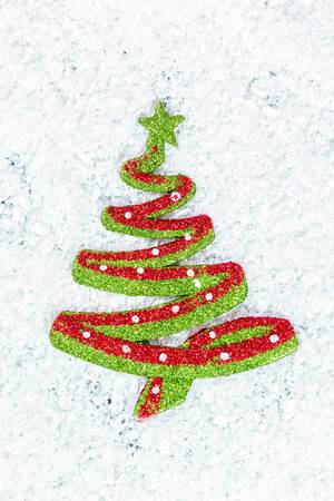 New year toy Christmas tree on snow background