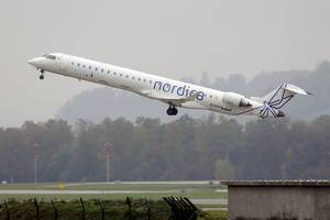 Nordica Bombardier airplane taking off from Zurich Airport