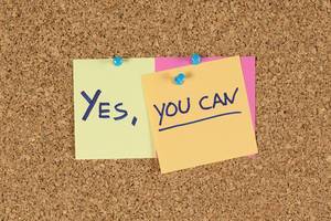 Notes on a pinboard with "yes, you can"  hand-written