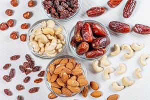 Nuts and dried fruits on a white wooden background. The concept of healthy food (Flip 2019)