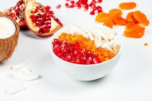Oatmeal porridge with fruit and coconut on a white background (Flip 2020)