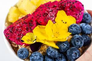 Oatmeal with fruit and flowers close-up (Flip 2020)