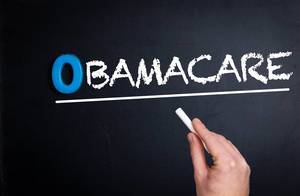 Obamacare text on blackboard