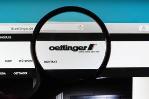 Oettinger logo under magnifying glass