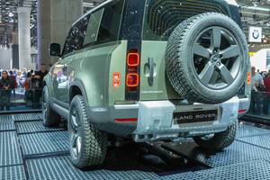 Off-road vehicle Land Rover Defender 90 D240 with geometric shaped tail lights and spare tire