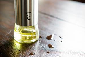 Oil bottle on dark wood table