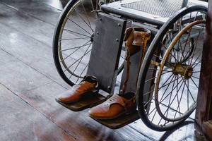 Old leather shoes on a vintage wwheelchair