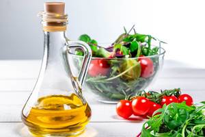 Olive oil with ingredients for diet salad