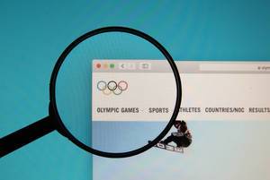 Olympic Games logo on a computer screen with a magnifying glass