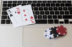 Online Gambling: Poker cards and chips on a laptop