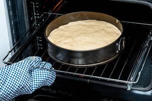 Open electric oven with baking tray and cake dough (Flip 2019)