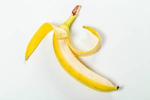 Open ripe banana on white background (Flip 2019)