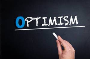 Optimism text on blackboard