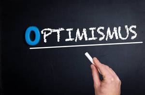 Optimismus text on blackboard